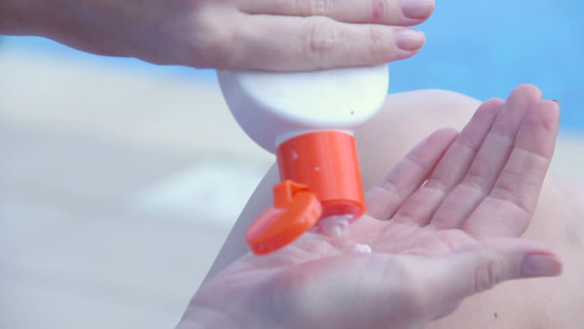 Extreme Closeup Of Female Hands Applying Suncream Rubbing Belly Stock