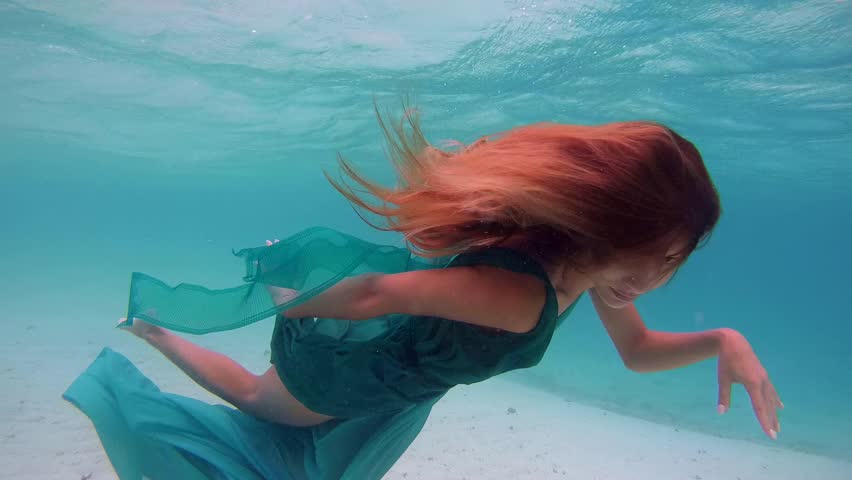 Underwater Young Beautiful Girl In Dress Posing Submerged Under Water