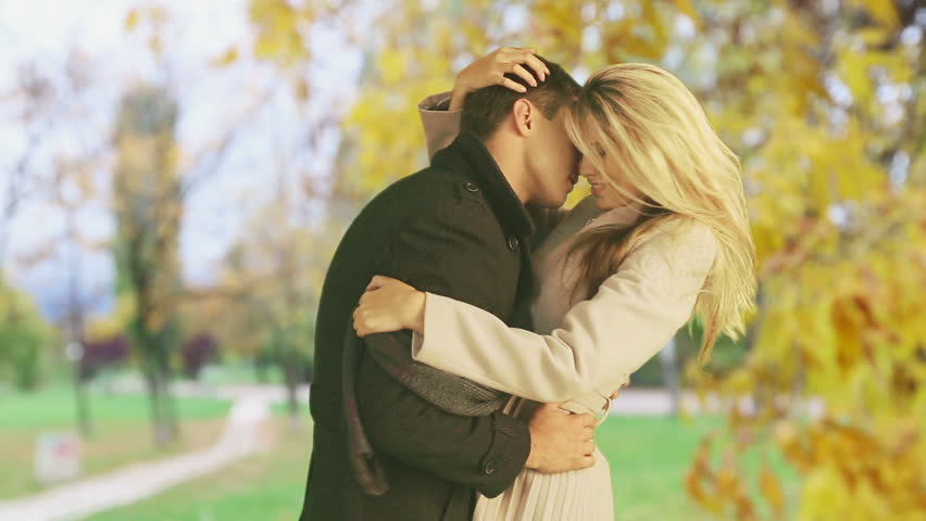 Man And Woman Kissing Madly Beautiful In Autumn Park She Leans Back Giving Neck And Chest To 
