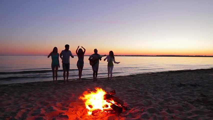 Young People Dance And Sing On The Beach Camping On The Island Youth