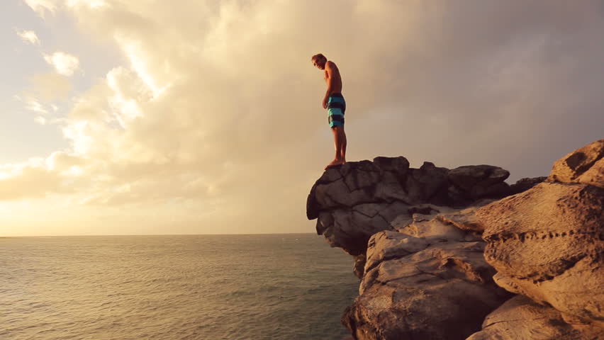 Young Man Jumps Off Cliff Into Water Summer Extreme Sports Outdoor Lifestyle Cliff Jumping At