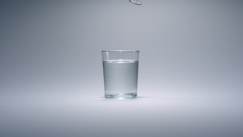 super-slo-mo-quarter-falling-into-glass-of-water-stock-footage-video