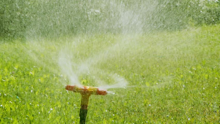 Sprinkler And Naked Child Running Through It Stock Footage 