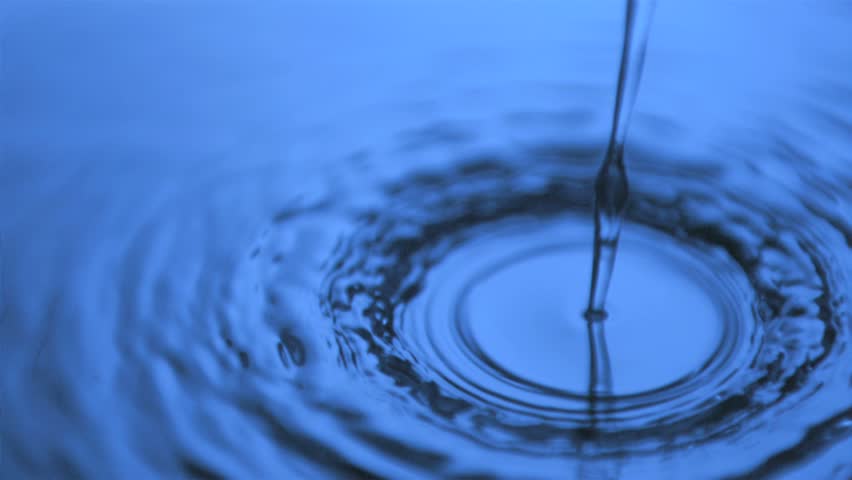 Water Dripping In Super Slow Motion On A Surface Under Blue Light Stock 