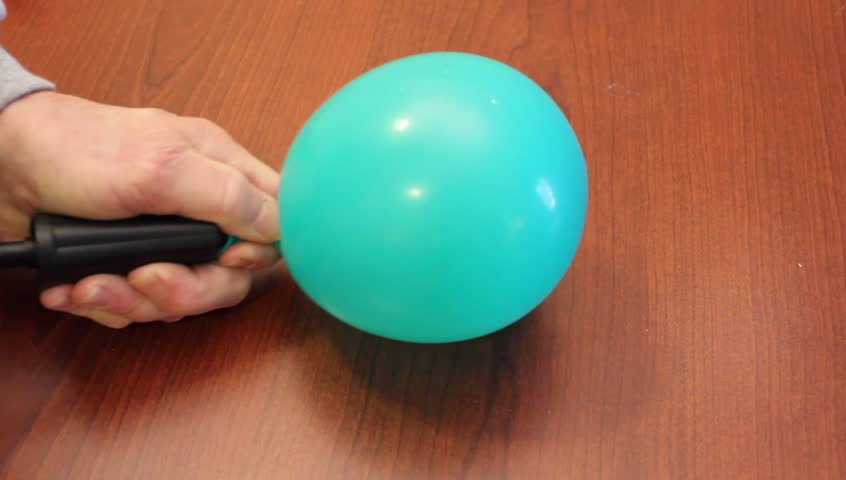 blowing-up-a-balloon-with-a-manual-air-pump-stock-footage-video-3493235