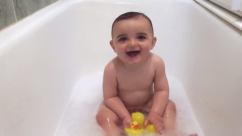 Small Child The Age Of One Year Plays And Jumps In Bathroom Baby In Bathtub 10 Months Old Playing At Bath Time With Duck Toy Hd Stock Footage Clip
