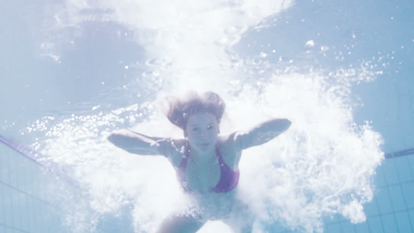 Beautiful Woman In A Pink Bikini Diving In And Swimming 