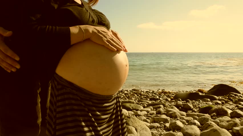 Pregnant Woman With Husband Rubbing Her Belly On The Beach Sepiafilm Burn Stock Footage Video 
