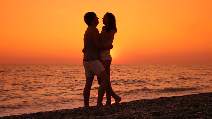 Couple Kissing By The Ocean At Sunset Stock Footage Video