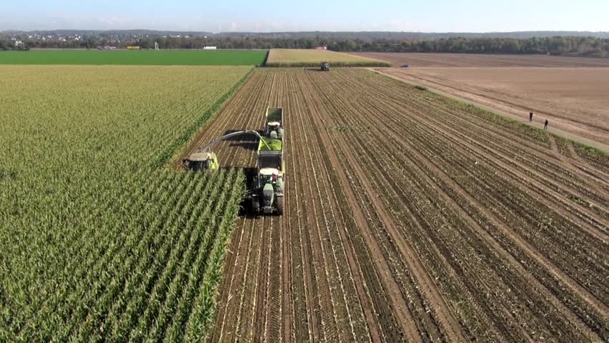 Aerial View Of A Farmer With A Thresher , Tractor And Trailer 