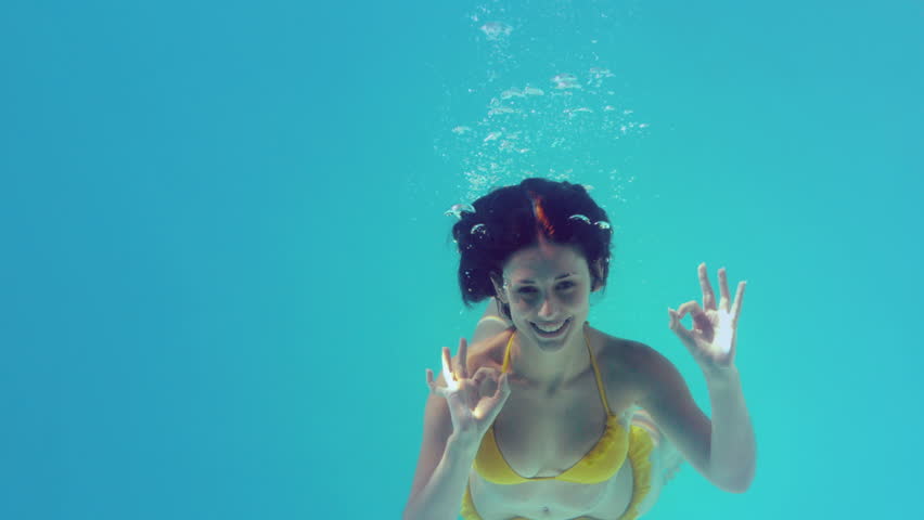 Gorgeous Brunette In Yellow Bikini Swimming Underwater In