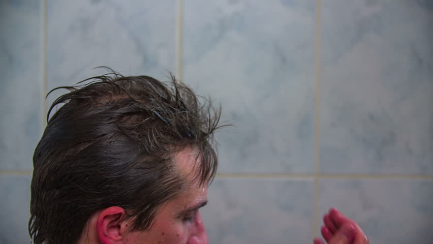 Washing Hair In Shower Attractive Male Under A Puts Shampoo In Hair