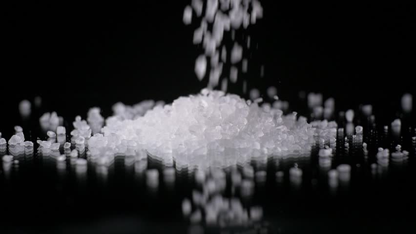 Salt Grain Crystals Falling In Slow Motion On Black Background Stock ...