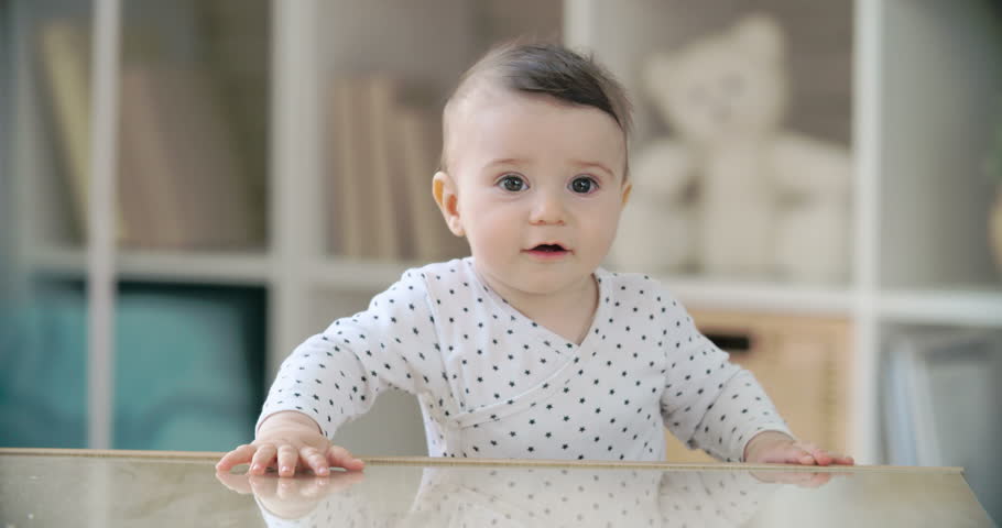 Happy Baby Boy Slapping The Table And Giving A Charming Smile Stock ...