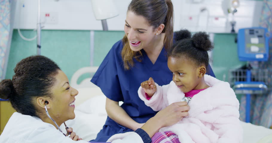 Attractive Female Nurse Listens To A Little Boy's Heartbeat Using A ...