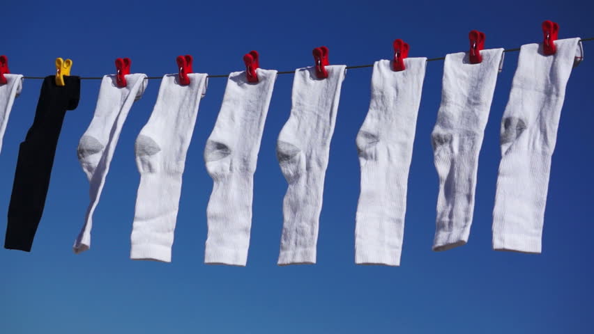 Sliding Dolly Shot Of White Socks Hanging On A Clothes Line And Blowing ...