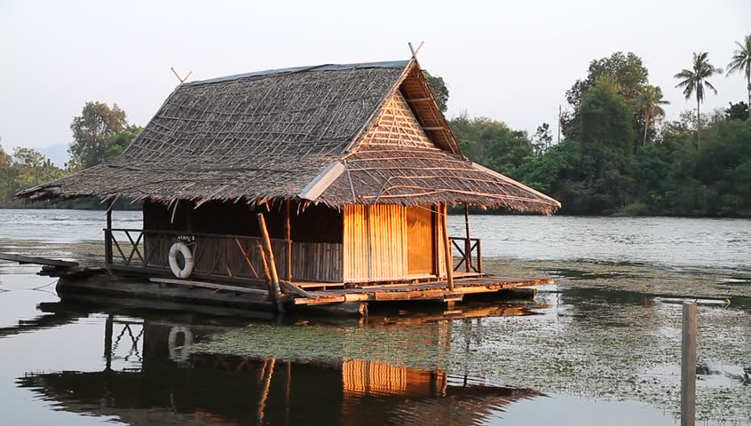 Two Lovely Bamboo Huts On Stilts Stand Over A Pond Near A Marsh In ...