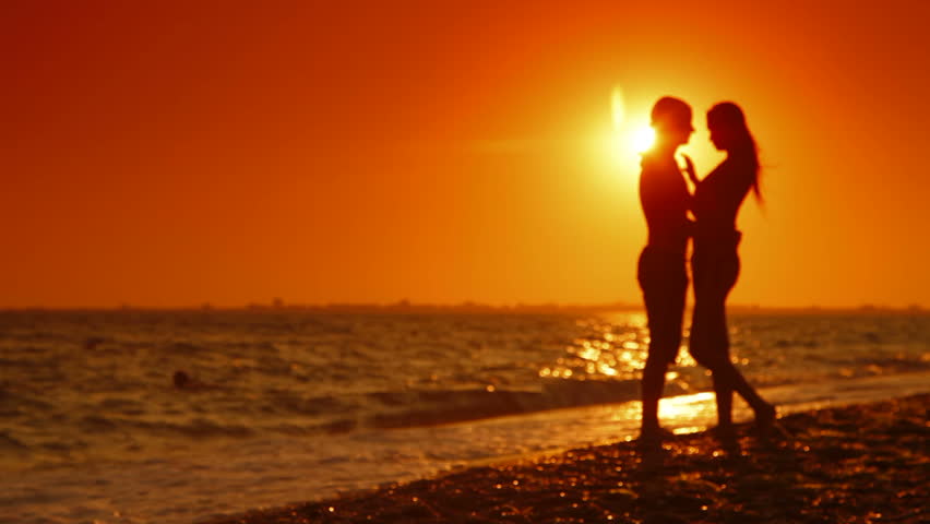 Honeymoon Passionate Couple Kissing On The Beach. Beautiful Sunset ...