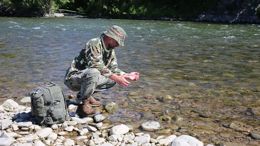 Hiker Drinking Water From The River In The Hands Of A Hot Day. Stock ...