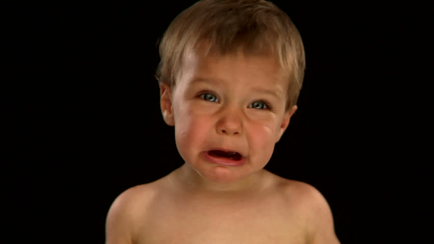 A Young Blond Boy Wears Glasses And Makes A Sad Face On A Black ...