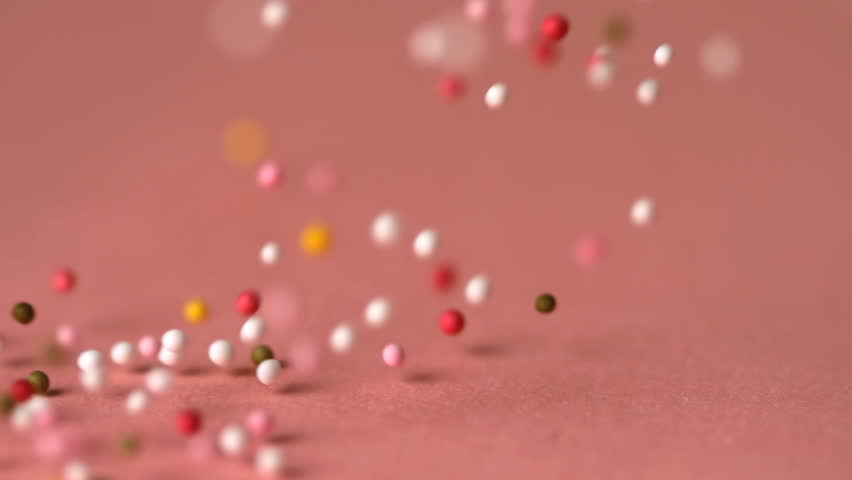 Sprinkles Falling On Pink Surface In Slow Motion Stock Footage Video ...