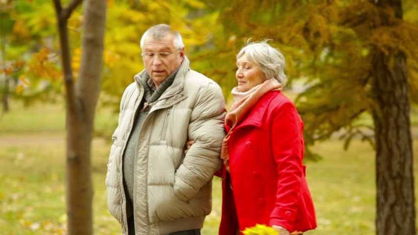 Retired Husband And Wife Walking And Talking In The Open Air Stock ...