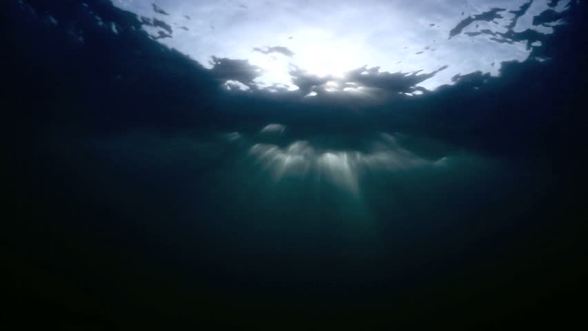 Underwater View Of Sunset Light Rays Shining Through The Ocean Surface ...