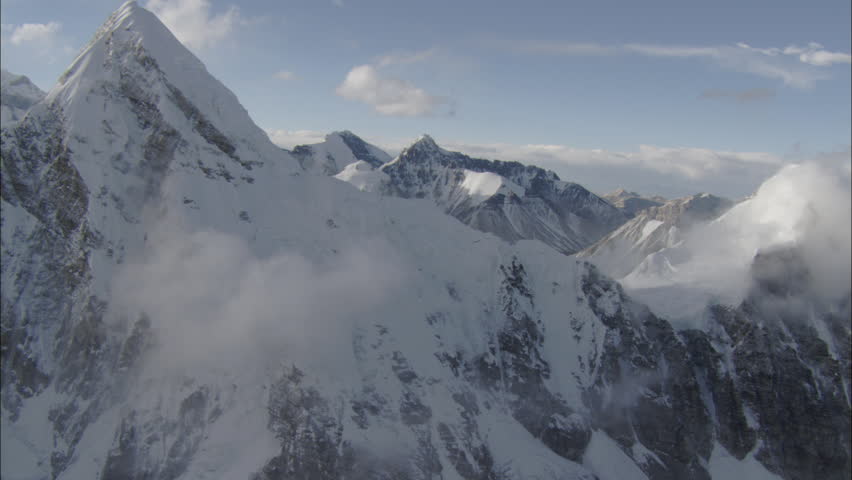 Snow Peaks Rocky Mountains Clouds. A High Altitude Shot Of White Snow ...