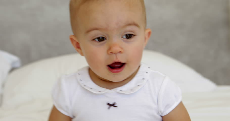 Cute Baby Girl Standing And Clapping On Bed At Home In Bedroom Stock ...