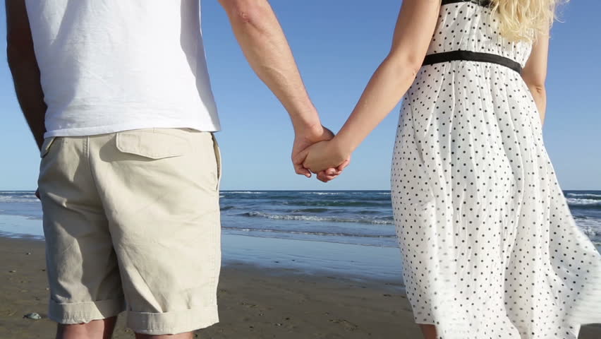 Holding Hands - Romantic Couple On Beach. Close Up Of Young Lovers ...