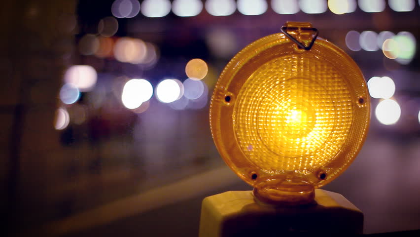 A Caution Sign Is Lit Up By A Blinking Yellow Warning Light Stock ...