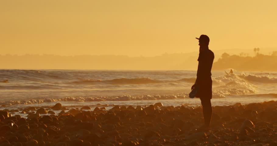 MALIBU, CALIFORNIA - August 29, 2014: Young Man Standing On Ocean Beach ...