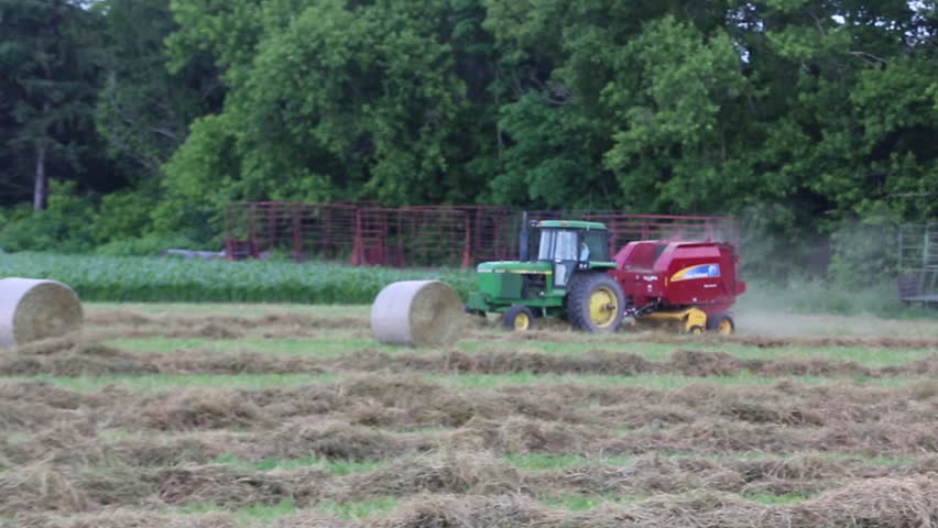 Round Hay Baler Scoops Up Dry Hay For Baling Stock Footage Video ...