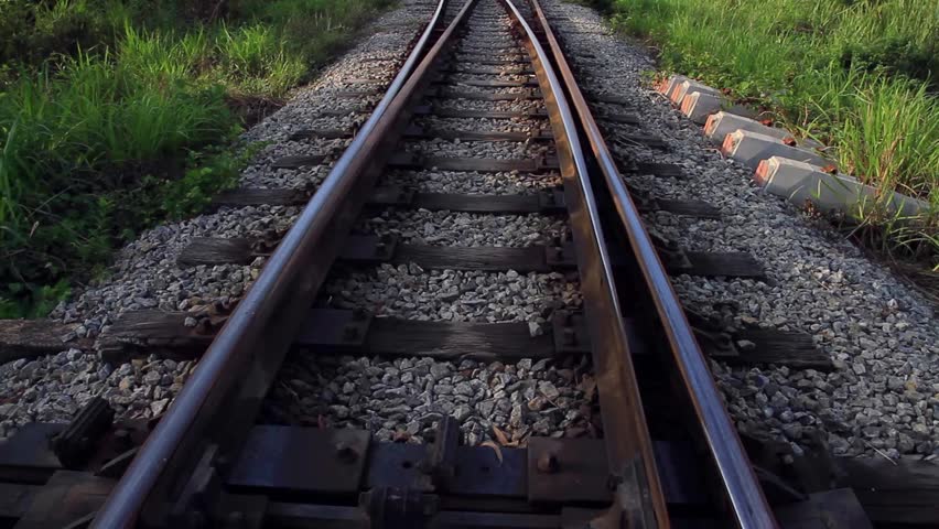 Close Up View Along Wooden Support Beams Of Rusted Railroad Tracks ...